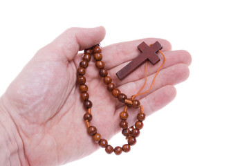 Hand Holding a Rosary Cross on Isolated White