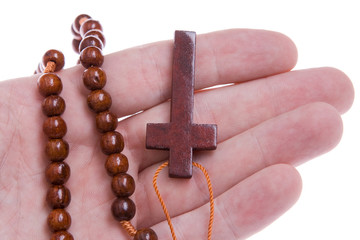 Hand Holding a Wooden Rosary Cross Isolated