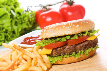 hamburger with fries and vegetables