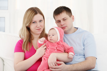 Happy family with the chest baby on hands