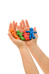 Hands folding colorful clay people
