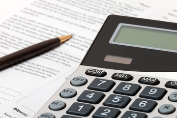 Calculator, pen and contract - business situation