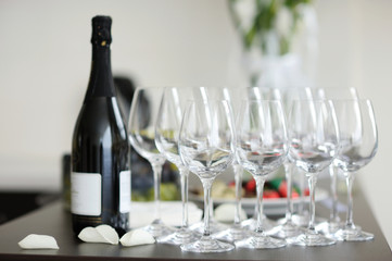 Few empty champagne glasses and a bottle of wine