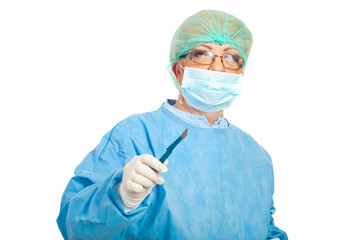 Mature surgeon woman with scalpel