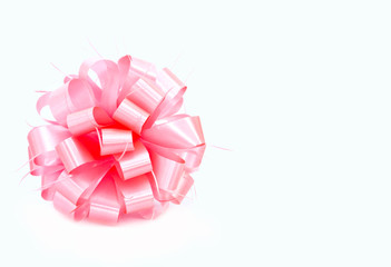 A pink ribbon bow on white background