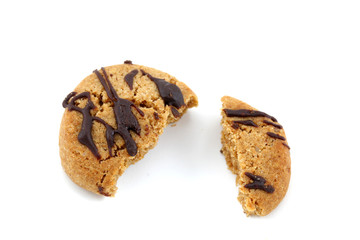 Halved and broken chocolate covered cookie on white