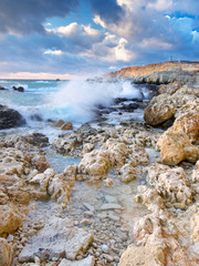 Seashore with stone during bright sundown
