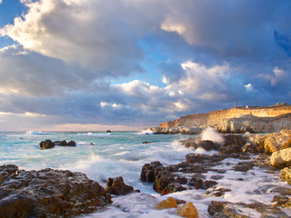 Sea bay and greater white clouds during sundown