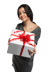 Young smiling woman holding gift isolated on white