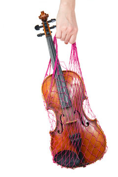 Female hand holding a red mesh with the violin, isolated, on a w