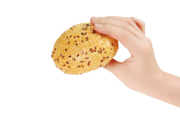 Bun, topped with sesame seeds in hand