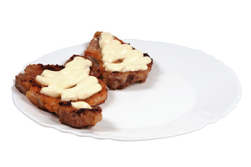 Grilled meat  with  mayonnaise  on a plate.