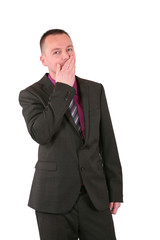 Young businessman covering his mouth with his hand