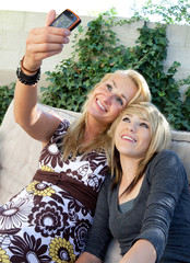 Mother and Teenage Daughter Taking Pictures with Mobile Phone Ca
