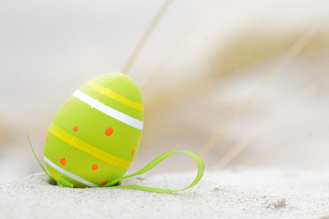 Easter decorated egg on sand