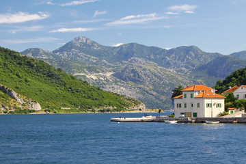 Fototapeta na wymiar Houses on the shore of Kotor Bay (Boka Kotorska), Montenegro