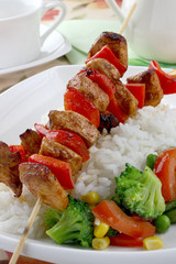 Chicken skewers, rice and vegetables