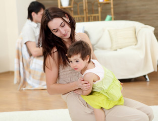 young mother playing with her baby at home