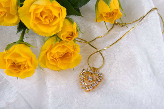 Beautiful yellow roses and golden heart