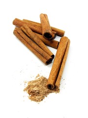Cinnamon sticks whole & grated on a white background