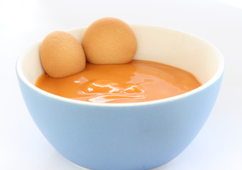 Red bowl with children fruit pap / mush with sponge-biscuits