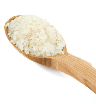 rice grain in wooden spoon isolated on white