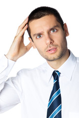 Portrait of puzzled young businessman, isolated on white