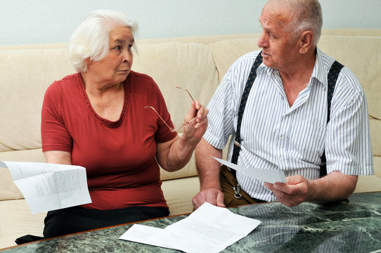 Senior Couple Reading Documents At Home