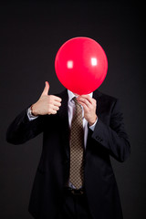 Businessman with a ball instead of head and making ok gesture