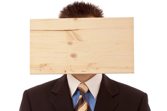 Mann-Gesch&auml;ftsmann mit Denkblockade-Brett vorm Kopf