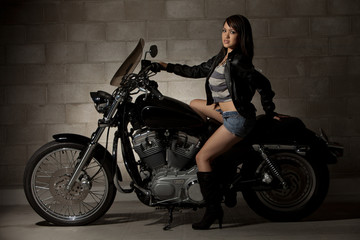 Plakat Sexy attractive twenties asian woman sitting on motorcycle