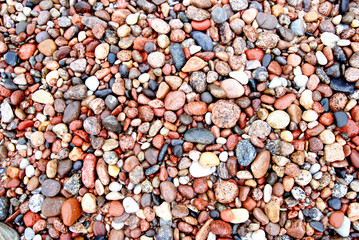 Colors and shapes of coastal stonnies moisten by sea waves.