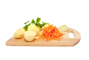 The cleared potato and grated carrots on a chopping board