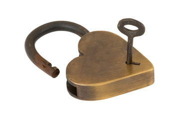 Isolated key in keyhole with  brass heart lock open