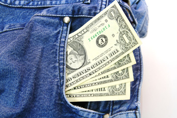 US dollar bills in blue jeans pocket.