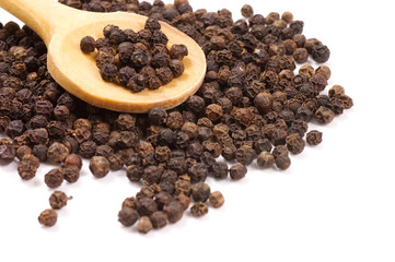 Black Peppercorns on a wooden spoon