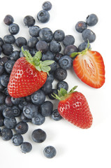 Blueberries and strawberries on a white background
