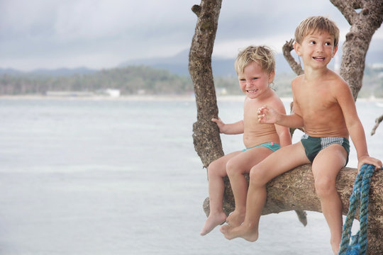 two children having fun on tree