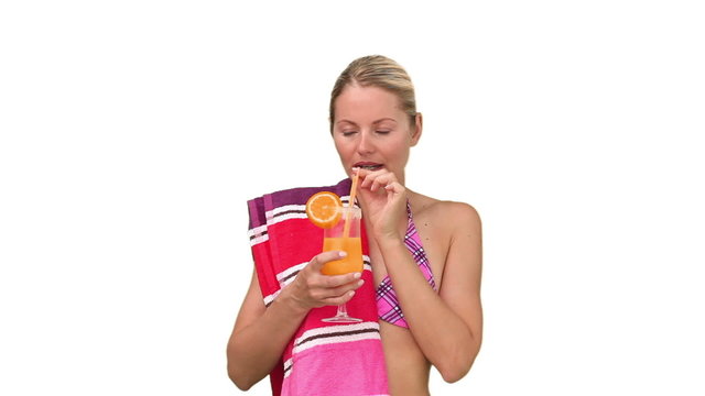 Pretty woman in swimsuit drinking cocktail