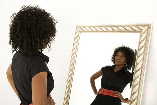 Lady looking at herself in mirror smiling