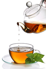 Tea dripping into cup (clipping path included)