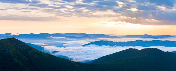 Fototapeta na wymiar Summer cloudy sunrise mountain panorama