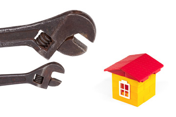 Two wrenches and toy house