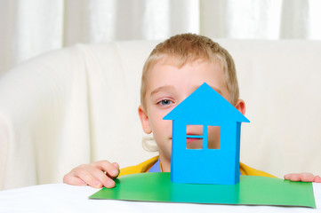a boy in studio playing with a house