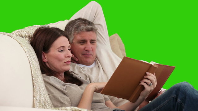 Cute middle-age couple looking at an album