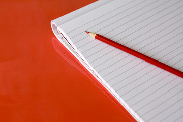 Block note and red pencil
