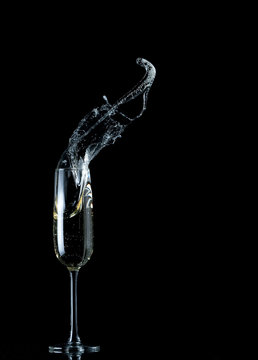 champagne flute splash isolated on black background