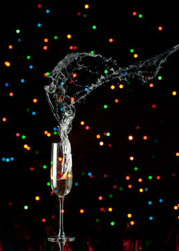 champagne flute with splash and colored lights
