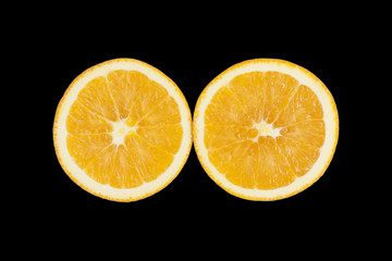 Two pieces of orange, showing texture on black background.