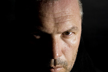 Low key portrait of menacing looking caucasian man